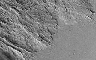 <h1>PIA03049:  Martian Lava Flows</h1><div class="PIA03049" lang="en" style="width:504px;text-align:left;margin:auto;background-color:#000;padding:10px;max-height:150px;overflow:auto;"><p>19 October 2005<br />This Mars Global Surveyor (MGS) Mars Orbiter Camera (MOC) image shows lava flows at the southeast base of the giant volcano, Olympus Mons. The flat plain in the south-southeast (bottom/lower right) portion of the image is younger than and cuts off the ends of many of the lava flows that came from the northwest (upper left). Many of the lava flows in this image exhibit channels with levees bounding their margins. As each lava flow was advancing, its outer margins cooled and hardened, forming a channel or tube through which the molten rock continued to advance.<p>Location near: 17.2°N, 129.0°W <br />Image width: width: ~3 km (~1.9 mi) <br />Illumination from: lower left <br />Season: Northern Winter</p><br /><br /><a href="http://photojournal.jpl.nasa.gov/catalog/PIA03049" onclick="window.open(this.href); return false;" title="Voir l'image 	 PIA03049:  Martian Lava Flows	  sur le site de la NASA">Voir l'image 	 PIA03049:  Martian Lava Flows	  sur le site de la NASA.</a></div>