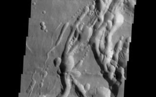 <h1>PIA03959:  Arsia Mons Southern Flank</h1><div class="PIA03959" lang="en" style="width:513px;text-align:left;margin:auto;background-color:#000;padding:10px;max-height:150px;overflow:auto;"><a href="/figures/PIA03959_fig1.jpg"></a><br /></p><p>The final VIS image of Arsia Mons is located on the southern flank of the volcano adjacent to the NE trending feature. There has been a significant amount of collapse features formed in this region. </p><p>Image information: VIS instrument. Latitude -11.1, Longitude 238.6 East (121.4 West). 17 meter/pixel resolution.</p><p>Note: this THEMIS visual image has not been radiometrically nor geometrically calibrated for this preliminary release. An empirical correction has been performed to remove instrumental effects. A linear shift has been applied in the cross-track and down-track direction to approximate spacecraft and planetary motion. Fully calibrated and geometrically projected images will be released through the Planetary Data System in accordance with Project policies at a later time.</p><p>NASA's Jet Propulsion Laboratory manages the 2001 Mars Odyssey mission for NASA's Office of Space Science, Washington, D.C. The Thermal Emission Imaging System (THEMIS) was developed by Arizona State University, Tempe, in collaboration with Raytheon Santa Barbara Remote Sensing. The THEMIS investigation is led by Dr. Philip Christensen at Arizona State University. Lockheed Martin Astronautics, Denver, is the prime contractor for the Odyssey project, and developed and built the orbiter. Mission operations are conducted jointly from Lockheed Martin and from JPL, a division of the California Institute of Technology in Pasadena.</p><br /><br /><a href="http://photojournal.jpl.nasa.gov/catalog/PIA03959" onclick="window.open(this.href); return false;" title="Voir l'image 	 PIA03959:  Arsia Mons Southern Flank	  sur le site de la NASA">Voir l'image 	 PIA03959:  Arsia Mons Southern Flank	  sur le site de la NASA.</a></div>