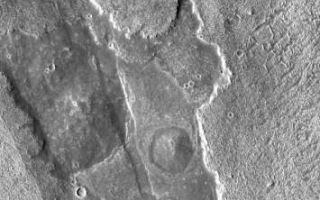 <h1>PIA03965:  Arsia Mons Overlapping Flows</h1><div class="PIA03965" lang="en" style="width:355px;text-align:left;margin:auto;background-color:#000;padding:10px;max-height:150px;overflow:auto;"><a href="/figures/PIA03965_fig1.jpg"></a><br /></p><p>This VIS image shows overlapping flows with different suface textures. In the middle of the image there is a round, darker feature -- a small volcano. To the left of the volcano a graben cuts across the lava flows.</p><p>Image information: VIS instrument. Latitude -18.5, Longitude 244.5 East (115.5 West). 17 meter/pixel resolution.</p><p>Note: this THEMIS visual image has not been radiometrically nor geometrically calibrated for this preliminary release. An empirical correction has been performed to remove instrumental effects. A linear shift has been applied in the cross-track and down-track direction to approximate spacecraft and planetary motion. Fully calibrated and geometrically projected images will be released through the Planetary Data System in accordance with Project policies at a later time.</p><p>NASA's Jet Propulsion Laboratory manages the 2001 Mars Odyssey mission for NASA's Office of Space Science, Washington, D.C. The Thermal Emission Imaging System (THEMIS) was developed by Arizona State University, Tempe, in collaboration with Raytheon Santa Barbara Remote Sensing. The THEMIS investigation is led by Dr. Philip Christensen at Arizona State University. Lockheed Martin Astronautics, Denver, is the prime contractor for the Odyssey project, and developed and built the orbiter. Mission operations are conducted jointly from Lockheed Martin and from JPL, a division of the California Institute of Technology in Pasadena.</p><br /><br /><a href="http://photojournal.jpl.nasa.gov/catalog/PIA03965" onclick="window.open(this.href); return false;" title="Voir l'image 	 PIA03965:  Arsia Mons Overlapping Flows	  sur le site de la NASA">Voir l'image 	 PIA03965:  Arsia Mons Overlapping Flows	  sur le site de la NASA.</a></div>