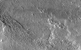 <h1>PIA03981:  Windstreak on Lava Flow</h1><div class="PIA03981" lang="en" style="width:382px;text-align:left;margin:auto;background-color:#000;padding:10px;max-height:150px;overflow:auto;"><a href="/figures/PIA03981_fig1.jpg"></a><br /></p><p>Today's image of the flows west of Arsia Mons also contains a large windstreak. Note the the surface texture in the "white" part of  the windstreak is more subdued than the rest of the flow. This is because the wind has deposited fine materials in this area. The wind can both erode the surface and cover it with deposits. </p><p>Image information: VIS instrument. Latitude -7.7, Longitude 227.5 East (132.5 West). 17 meter/pixel resolution.</p><p>Note: this THEMIS visual image has not been radiometrically nor geometrically calibrated for this preliminary release. An empirical correction has been performed to remove instrumental effects. A linear shift has been applied in the cross-track and down-track direction to approximate spacecraft and planetary motion. Fully calibrated and geometrically projected images will be released through the Planetary Data System in accordance with Project policies at a later time.</p><p>NASA's Jet Propulsion Laboratory manages the 2001 Mars Odyssey mission for NASA's Office of Space Science, Washington, D.C. The Thermal Emission Imaging System (THEMIS) was developed by Arizona State University, Tempe, in collaboration with Raytheon Santa Barbara Remote Sensing. The THEMIS investigation is led by Dr. Philip Christensen at Arizona State University. Lockheed Martin Astronautics, Denver, is the prime contractor for the Odyssey project, and developed and built the orbiter. Mission operations are conducted jointly from Lockheed Martin and from JPL, a division of the California Institute of Technology in Pasadena.</p><br /><br /><a href="http://photojournal.jpl.nasa.gov/catalog/PIA03981" onclick="window.open(this.href); return false;" title="Voir l'image 	 PIA03981:  Windstreak on Lava Flow	  sur le site de la NASA">Voir l'image 	 PIA03981:  Windstreak on Lava Flow	  sur le site de la NASA.</a></div>