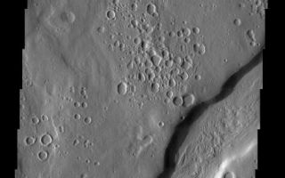 <h1>PIA04461:  Ismenia Fossae: Craters or Pits?</h1><div class="PIA04461" lang="en" style="width:473px;text-align:left;margin:auto;background-color:#000;padding:10px;max-height:150px;overflow:auto;"><p><a href="/figures/PIA04461_context.jpg"></a><br><p>Released 10 April 2003<p>The circular depressions prevalent throughout this scene at first glance appear to be craters, but are they? Could they be pits formed by devolatilization? It is not clear. We are studying these features in search of answers. Once again, another example of a Martian mystery.<p>Note: this THEMIS visual image has not been radiometrically nor geometrically calibrated for this preliminary release. An empirical correction has been performed to remove instrumental effects. A linear shift has been applied in the cross-track and down-track direction to approximate spacecraft and planetary motion. Fully calibrated and geometrically projected images will be released through the Planetary Data System in accordance with Project policies at a later time.<p>NASA's Jet Propulsion Laboratory manages the 2001 Mars Odyssey mission for NASA's Office of Space Science, Washington, D.C. The Thermal Emission Imaging System (THEMIS) was developed by Arizona State University, Tempe, in collaboration with Raytheon Santa Barbara Remote Sensing. The THEMIS investigation is led by Dr. Philip Christensen at Arizona State University. Lockheed Martin Astronautics, Denver, is the prime contractor for the Odyssey project, and developed and built the orbiter. Mission operations are conducted jointly from Lockheed Martin and from JPL, a division of the California Institute of Technology in Pasadena.<p>Image information: VIS instrument. Latitude 39.4, Longitude 40.9 East (319.1 West). 19 meter/pixel resolution.<p><br /><br /><a href="http://photojournal.jpl.nasa.gov/catalog/PIA04461" onclick="window.open(this.href); return false;" title="Voir l'image 	 PIA04461:  Ismenia Fossae: Craters or Pits?	  sur le site de la NASA">Voir l'image 	 PIA04461:  Ismenia Fossae: Craters or Pits?	  sur le site de la NASA.</a></div>