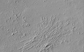 <h1>PIA04678:  Pedestal Crater and Yardangs</h1><div class="PIA04678" lang="en" style="width:540px;text-align:left;margin:auto;background-color:#000;padding:10px;max-height:150px;overflow:auto;">MGS MOC Release No. MOC2-444, 6 August 2003<p />This April 2003 Mars Global Surveyor (MGS) Mars Orbiter Camera (MOC) image shows a small meteor impact crater that has been modified by wind erosion. Two things happened after the crater formed. First, the upper few meters of surface material into which the meteor impacted was later eroded away by wind. The crater ejecta formed a protective armor that kept the material under the ejecta from been blown away. This caused the crater and ejecta to appear as if standing upon a raised platform--a feature that Mars geologists call a pedestal crater. Next, the pedestal crater was buried beneath several meters of new sediment, and then this material was eroded away by wind to form the array of sharp ridges that run across the pedestal crater's surface. These small ridges are known as yardangs. This picture is illuminated by sunlight from the upper left; it is located in west Daedalia Planum near 14.6°S, 131.9°W.<br /><br /><a href="http://photojournal.jpl.nasa.gov/catalog/PIA04678" onclick="window.open(this.href); return false;" title="Voir l'image 	 PIA04678:  Pedestal Crater and Yardangs	  sur le site de la NASA">Voir l'image 	 PIA04678:  Pedestal Crater and Yardangs	  sur le site de la NASA.</a></div>