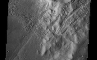 <h1>PIA04704:  Craters and Grabens: Circles and Lines</h1><div class="PIA04704" lang="en" style="width:463px;text-align:left;margin:auto;background-color:#000;padding:10px;max-height:150px;overflow:auto;"><p /><a href="/figures/PIA04704_context.jpg"></a><br /><p />Released 7 August 2003<p />Large grooves indicating tectonic faulting cross this image from the upper right to the lower left. This image is located not too far south of the Tharsis Montes, which probably produced the faulting seen here as they erupted and uplifted the terrain. Many craters are apparent on the surface here, some of which have impacted on the grabens (grooves), indicating that they are younger than the faults. The crater in the center of the image appears to have been breached, allowing material (perhaps a mudslide) to spill to the west. Could this flow be caused by an earthquake that occurred when the faults moved, or did it happen much later?<p />Image information: VIS instrument. Latitude -35.7, Longitude 324.1 East (35.9 West). 19 meter/pixel resolution.<p />Note: this THEMIS visual image has not been radiometrically nor geometrically calibrated for this preliminary release. An empirical correction has been performed to remove instrumental effects. A linear shift has been applied in the cross-track and down-track direction to approximate spacecraft and planetary motion. Fully calibrated and geometrically projected images will be released through the Planetary Data System in accordance with Project policies at a later time. <p />NASA's Jet Propulsion Laboratory manages the 2001 Mars Odyssey mission for NASA's Office of Space Science, Washington, D.C. The Thermal Emission Imaging System (THEMIS) was developed by Arizona State University, Tempe, in collaboration with Raytheon Santa Barbara Remote Sensing. The THEMIS investigation is led by Dr. Philip Christensen at Arizona State University. Lockheed Martin Astronautics, Denver, is the prime contractor for the Odyssey project, and developed and built the orbiter. Mission operations are conducted jointly from Lockheed Martin and from JPL, a division of the California Institute of Technology in Pasadena.<br /><br /><a href="http://photojournal.jpl.nasa.gov/catalog/PIA04704" onclick="window.open(this.href); return false;" title="Voir l'image 	 PIA04704:  Craters and Grabens: Circles and Lines	  sur le site de la NASA">Voir l'image 	 PIA04704:  Craters and Grabens: Circles and Lines	  sur le site de la NASA.</a></div>