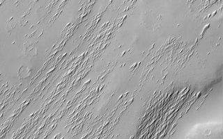 <h1>PIA05948:  Apollinaris Patera Erosion</h1><div class="PIA05948" lang="en" style="width:672px;text-align:left;margin:auto;background-color:#000;padding:10px;max-height:150px;overflow:auto;"><p>18 September 2004<br />Apollinaris Patera is an ancient volcano located northwest of Gusev Crater, the landing site of the Mars Exploration Rover, Spirit. Apollinaris Patera, being rather old, is covered with craters, mantles of dust, and a wind-scoured covering of indurated, fine material. This Mars Global Surveyor (MGS) Mars Orbiter Camera (MOC) image shows a small portion of the Apollinaris Patera volcano, revealing the exhumation of older surfaces from beneath a relatively thin, wind-scoured material. This view is located on the upper south slope of the volcano, near 9.5°S, 186.4°W. The image covers an area approximately 3 km (1.9 mi) across and is illuminated by sunlight from the upper left.</p><br /><br /><a href="http://photojournal.jpl.nasa.gov/catalog/PIA05948" onclick="window.open(this.href); return false;" title="Voir l'image 	 PIA05948:  Apollinaris Patera Erosion	  sur le site de la NASA">Voir l'image 	 PIA05948:  Apollinaris Patera Erosion	  sur le site de la NASA.</a></div>